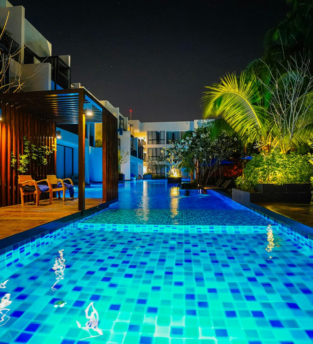 Outdoor swimming pool at a resort hotel illuminated at night