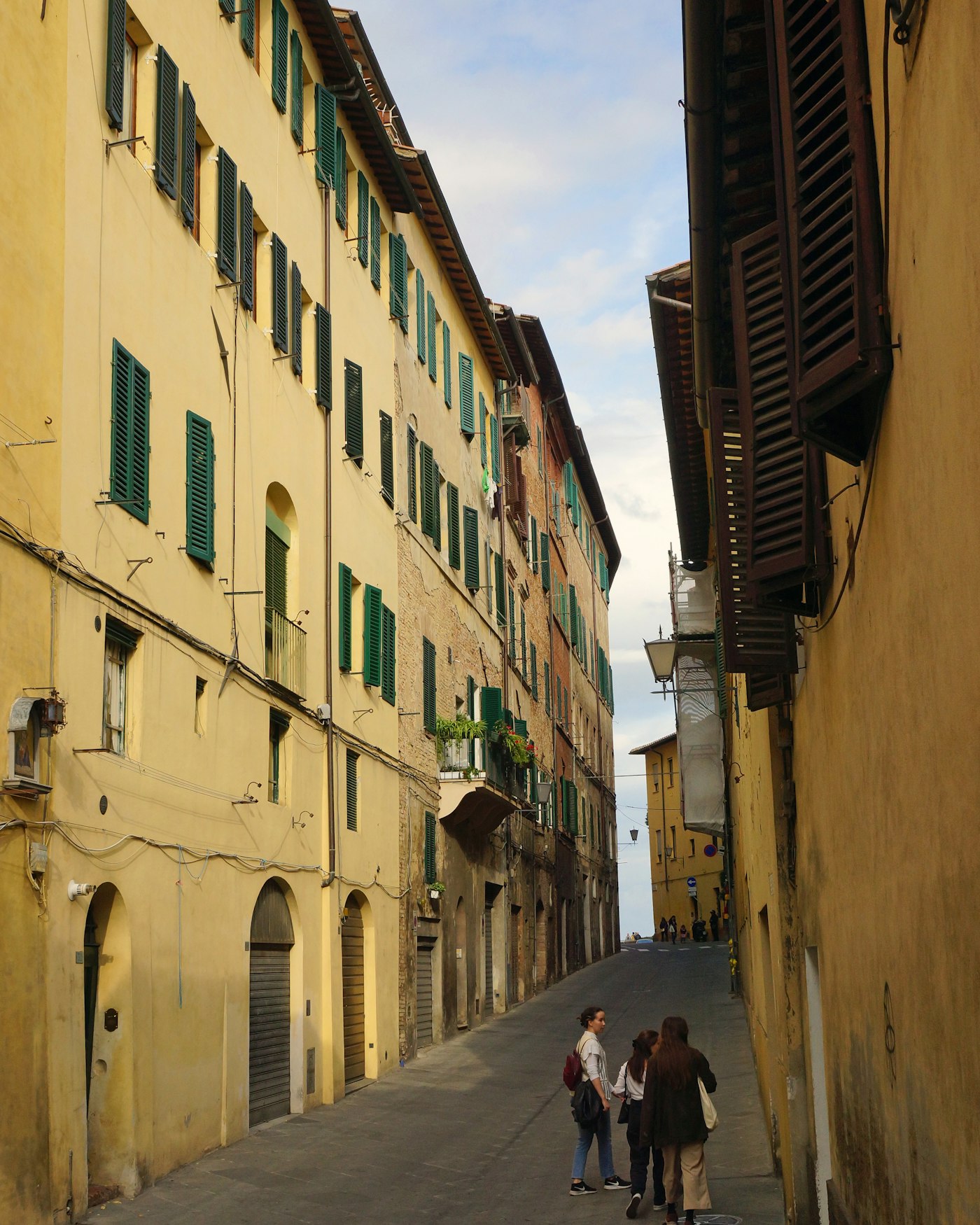Traveler walking through a cobblestone old-town street