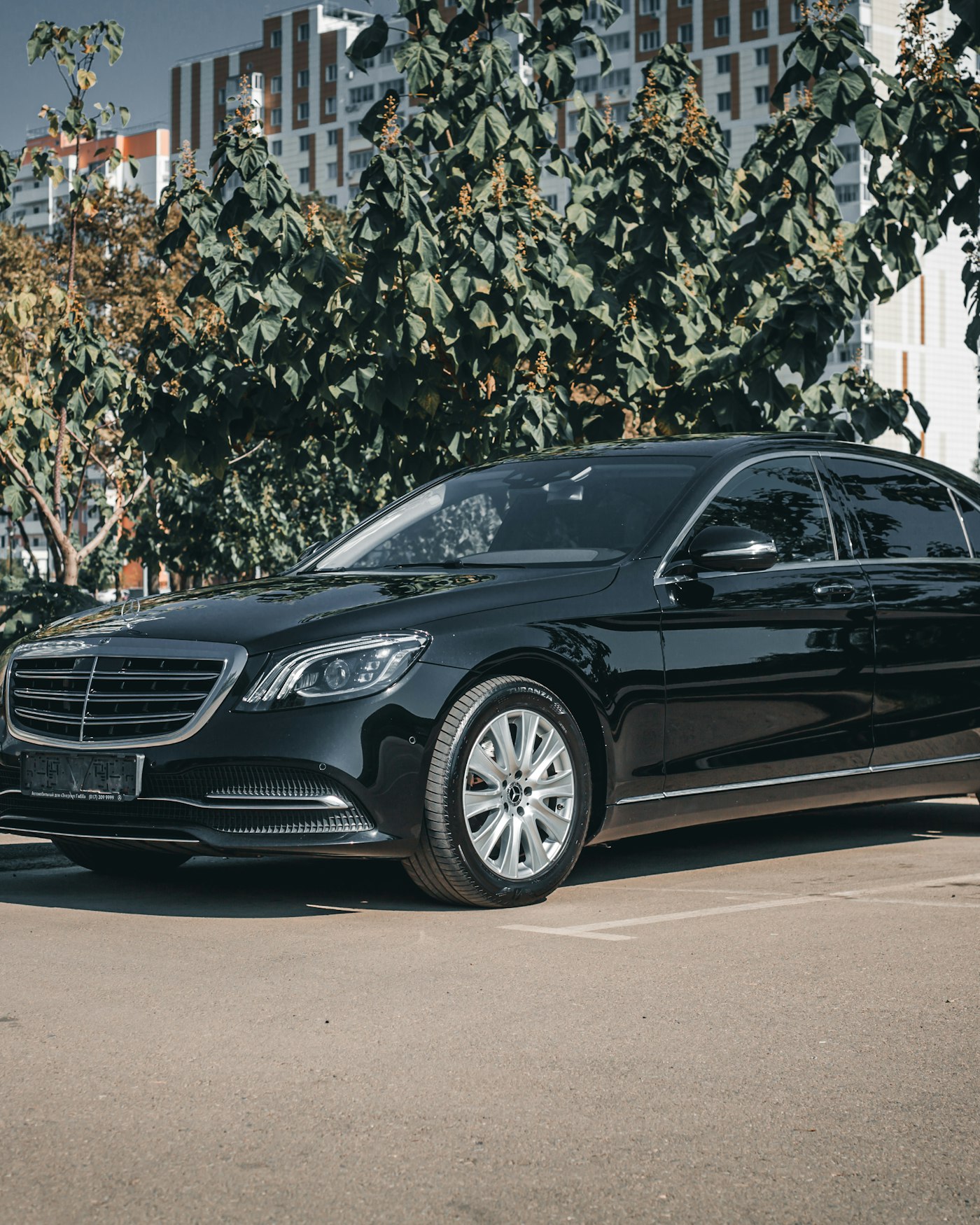 Black chauffeur-driven sedan used for airport transfer service